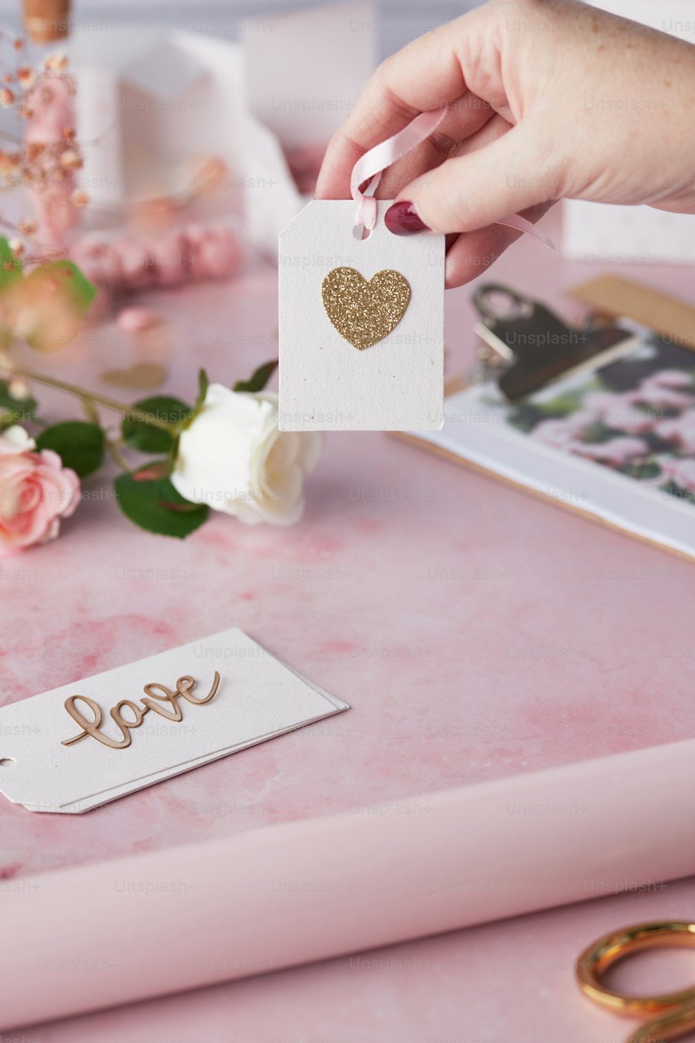 a person holding a card with a heart on it