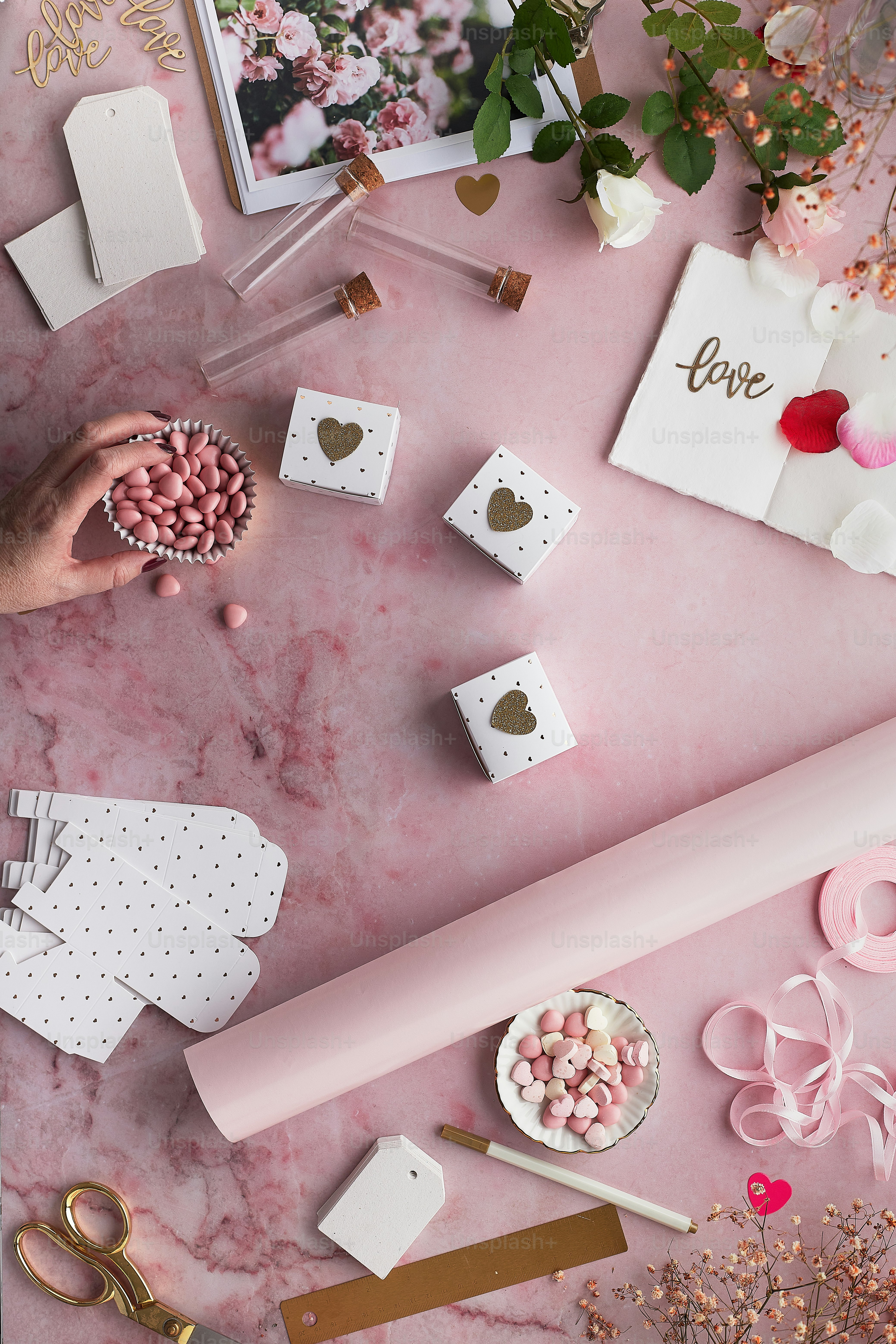 a pink table topped with lots of different items