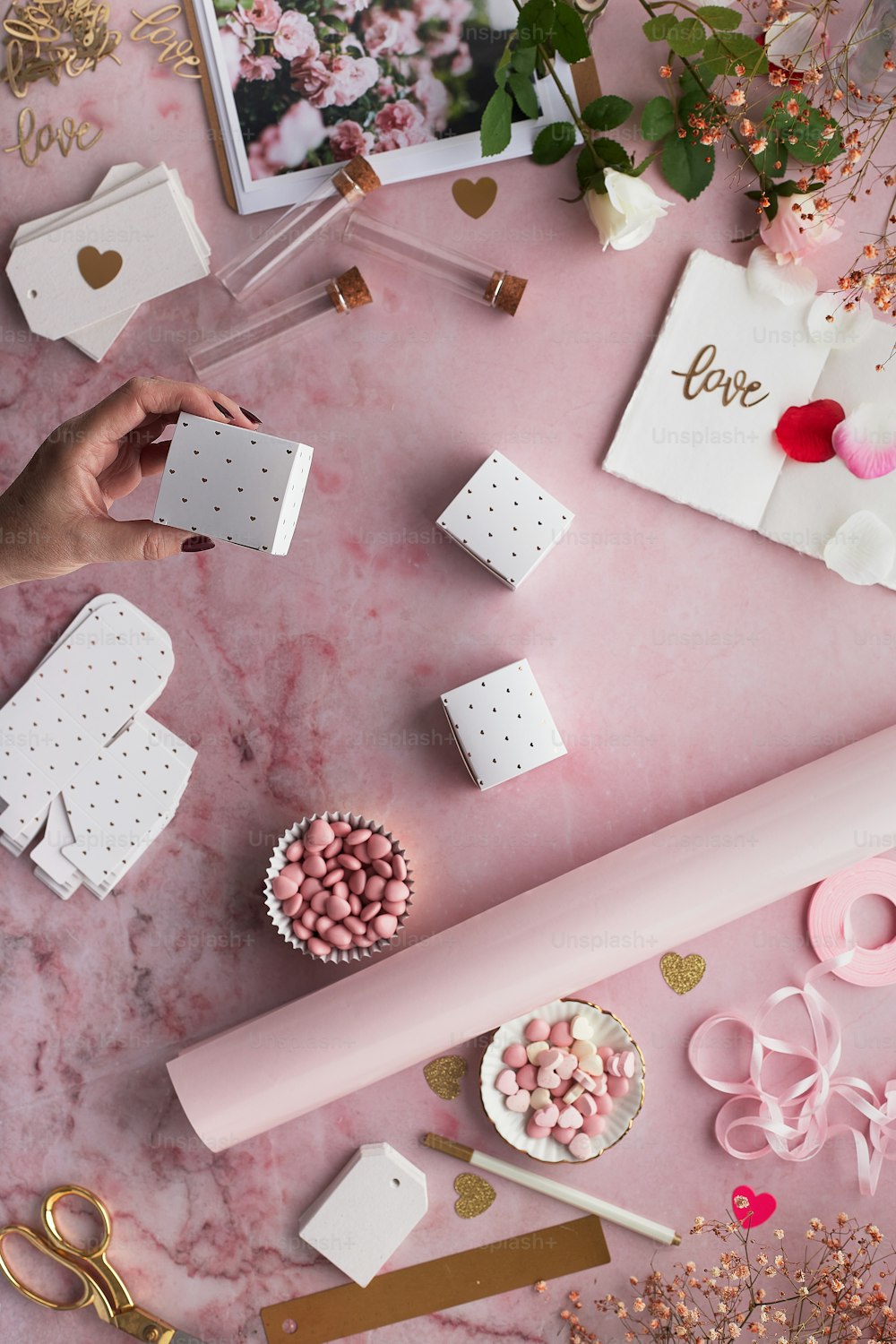 a table topped with lots of pink and white items