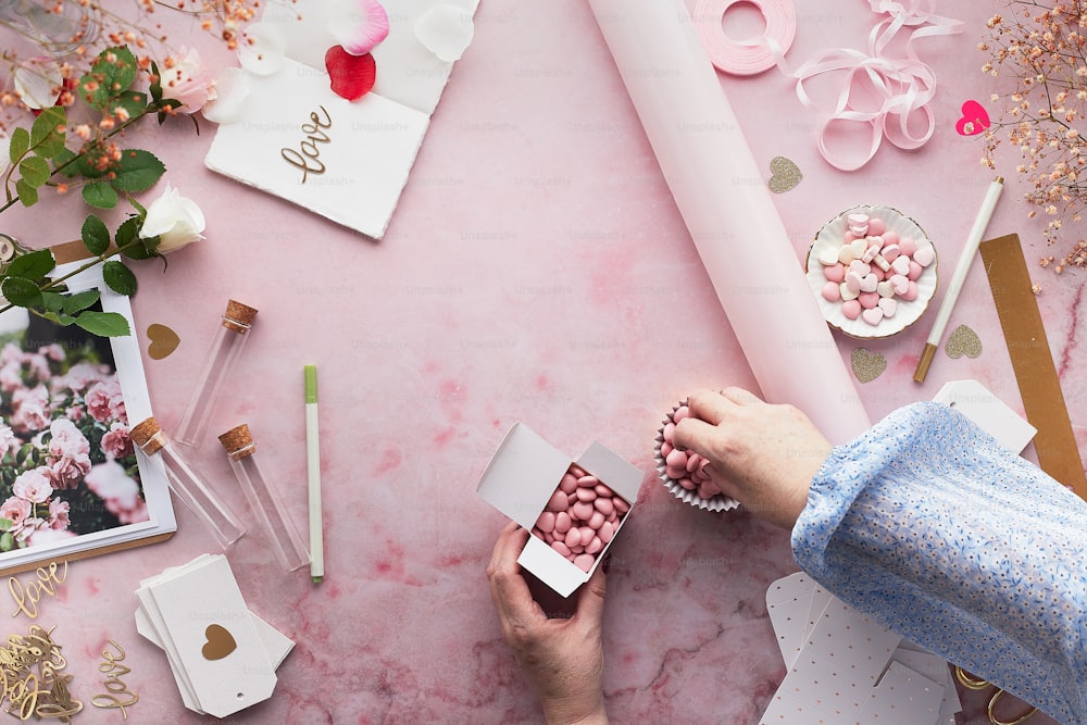 a person holding a box of pink candy