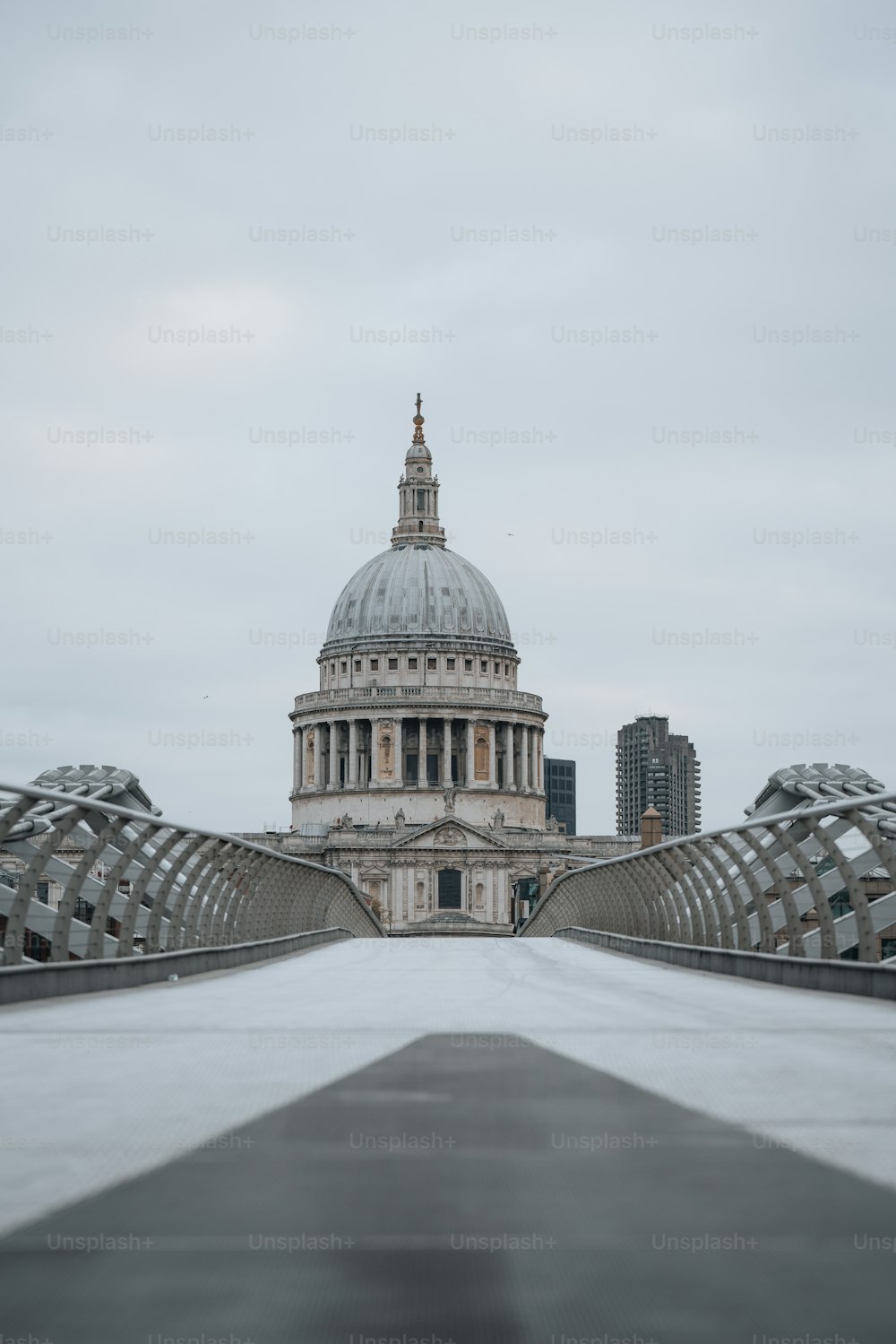 a view of the dome of st paul's cathedral from across the millennium bridge