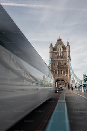 a blurry picture of a bridge with a car passing by