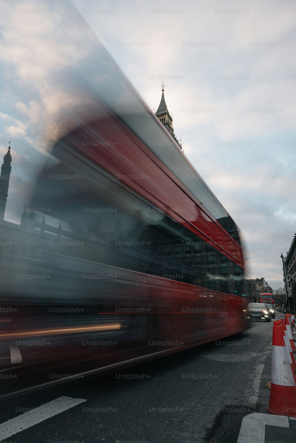 a red double decker bus driving down a street