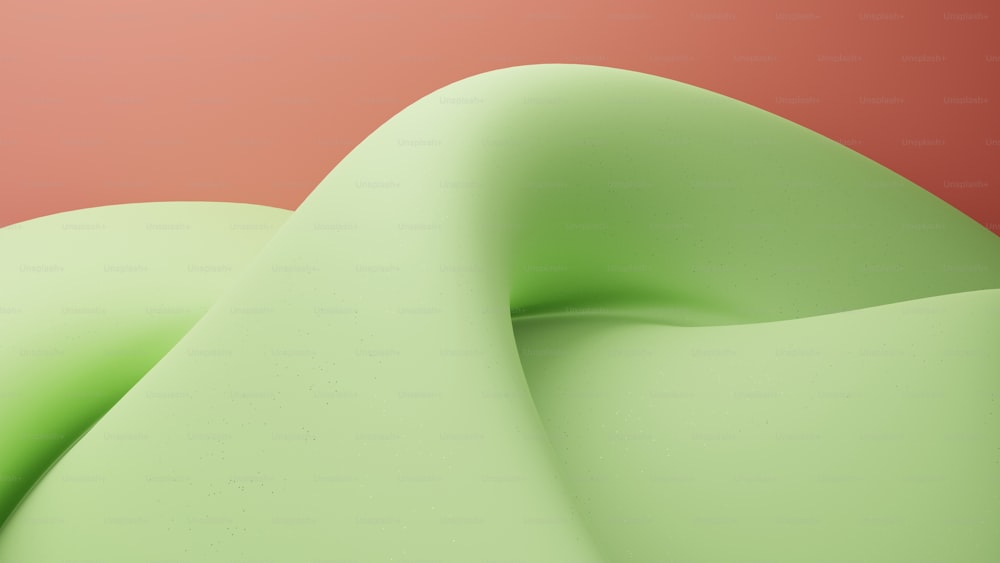 a close up of a green object with a red background