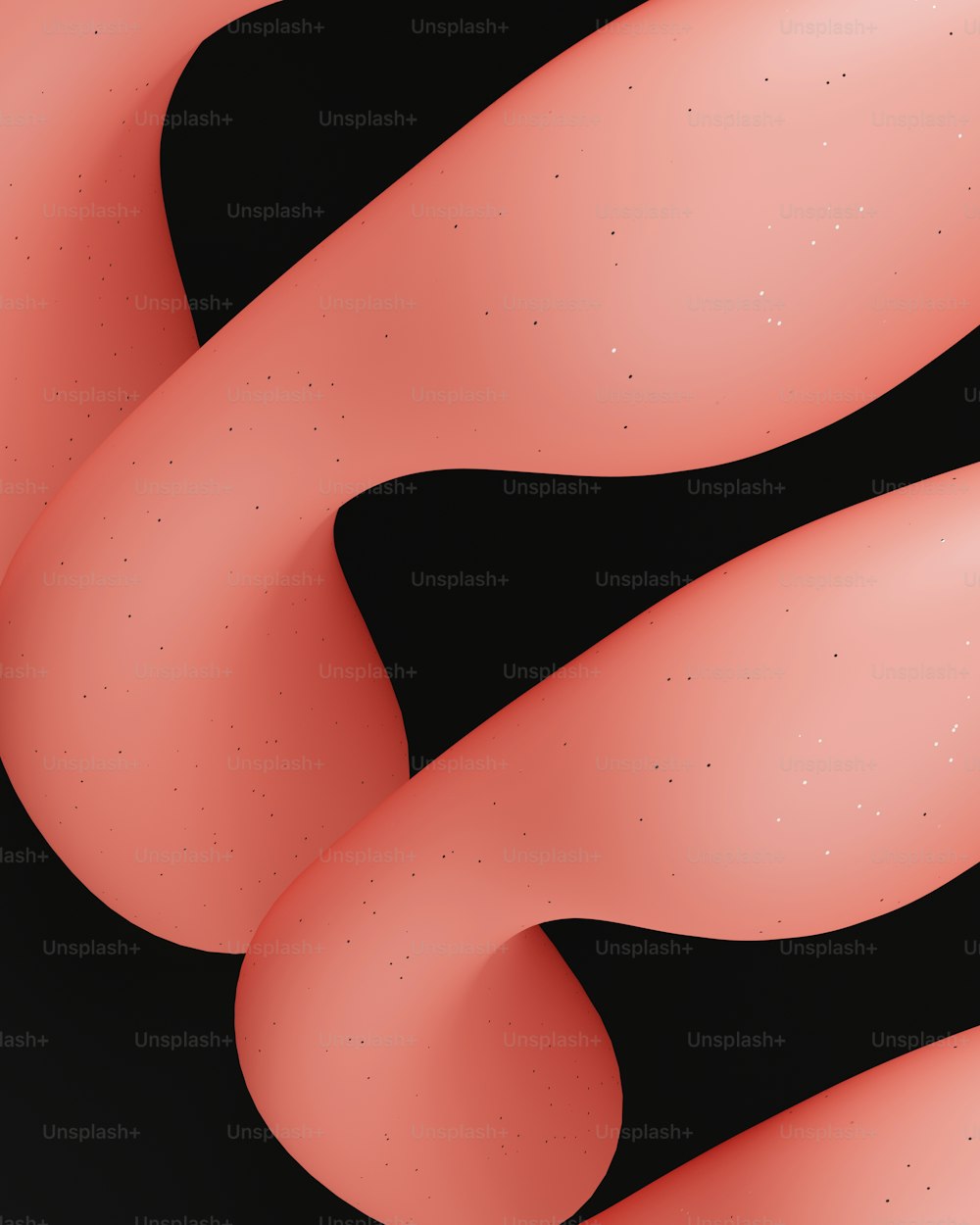 a close up of a black background with pink shapes