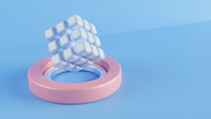ein rosa Ring mit einem weißen Würfel darüber