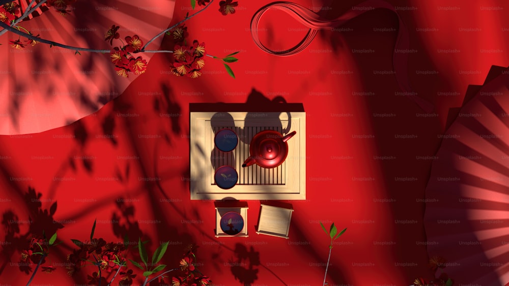 an overhead view of a red wall with a fan and vases