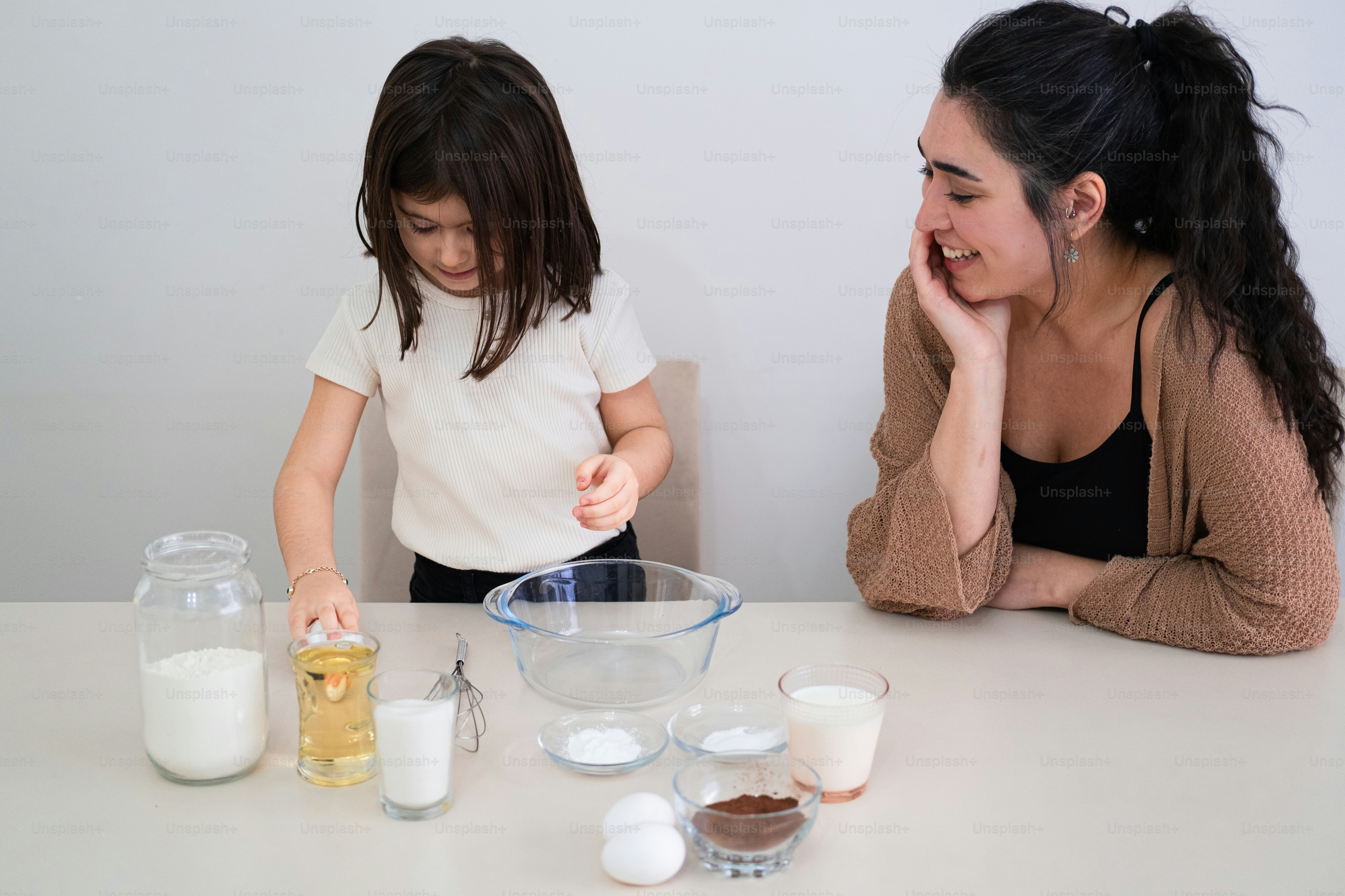 A woman and a little girl are making some food photo – Woman Image on ...