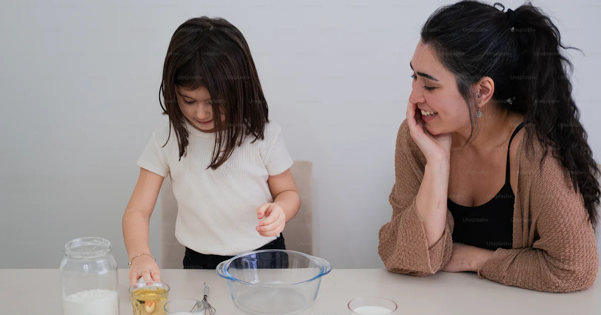 Making Some Food A woman and a little girl are making some food photo – Woman Image on ...
