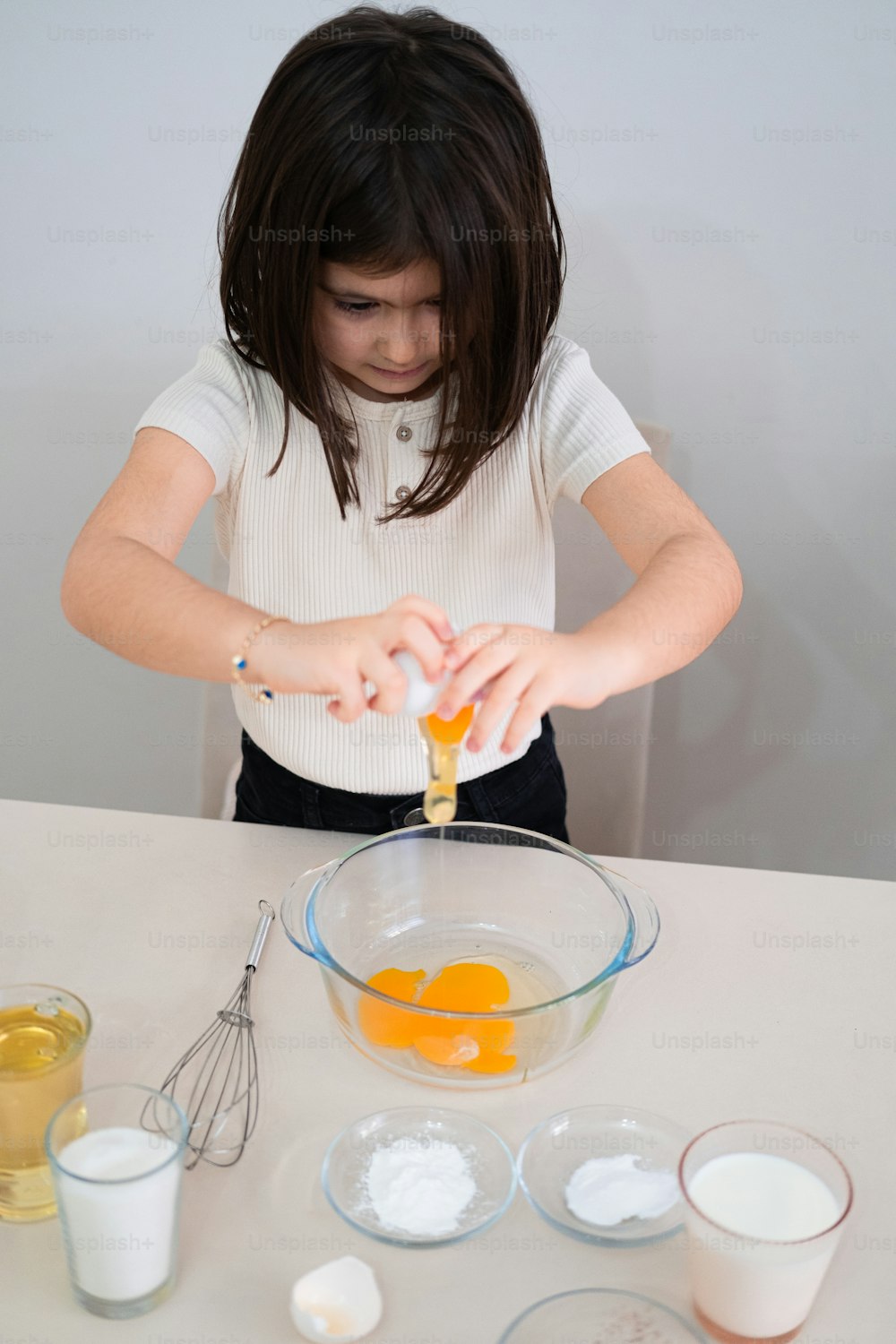 a young girl mixing ingredients in a bowl