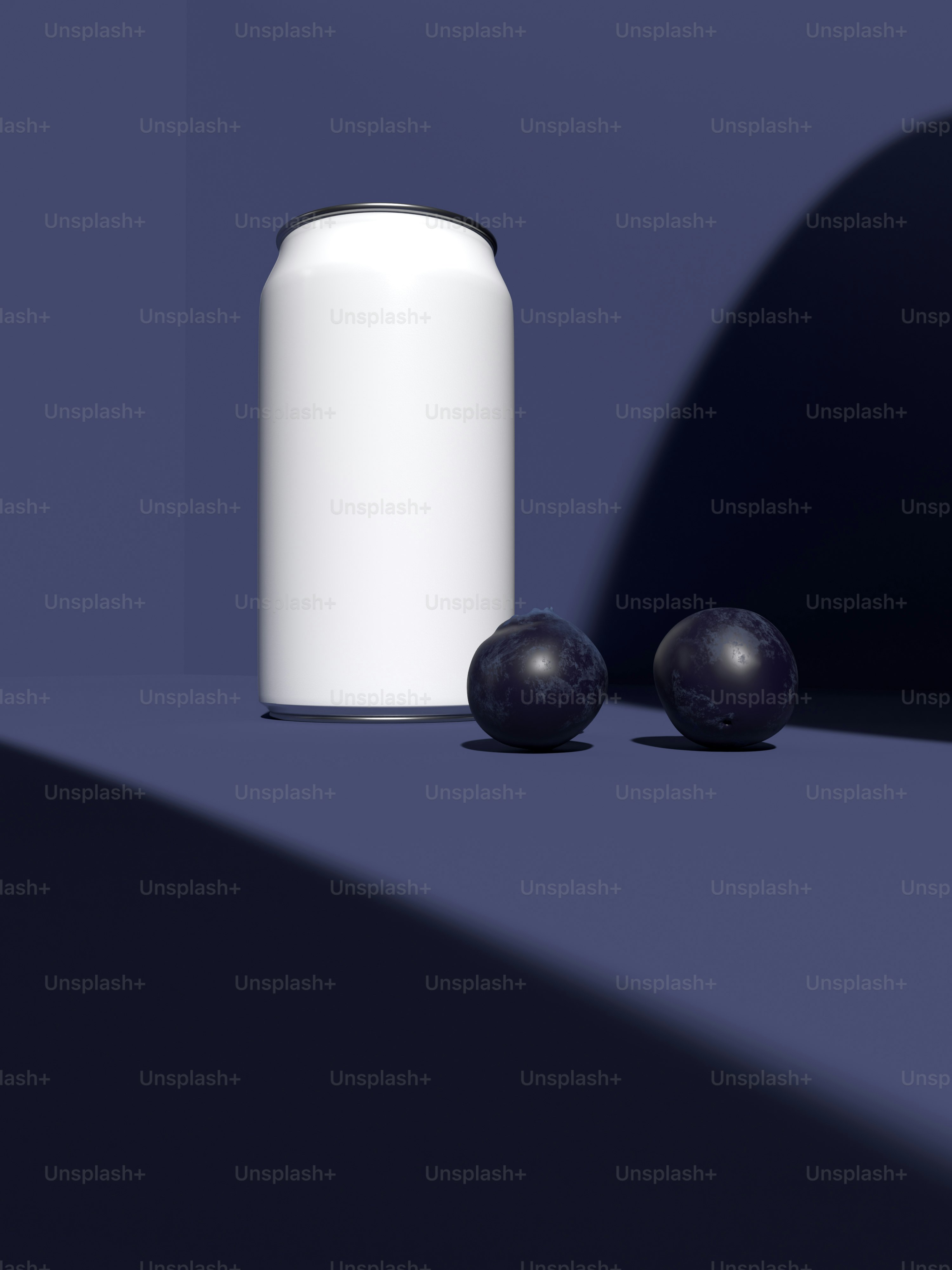 a can of soda next to two plums