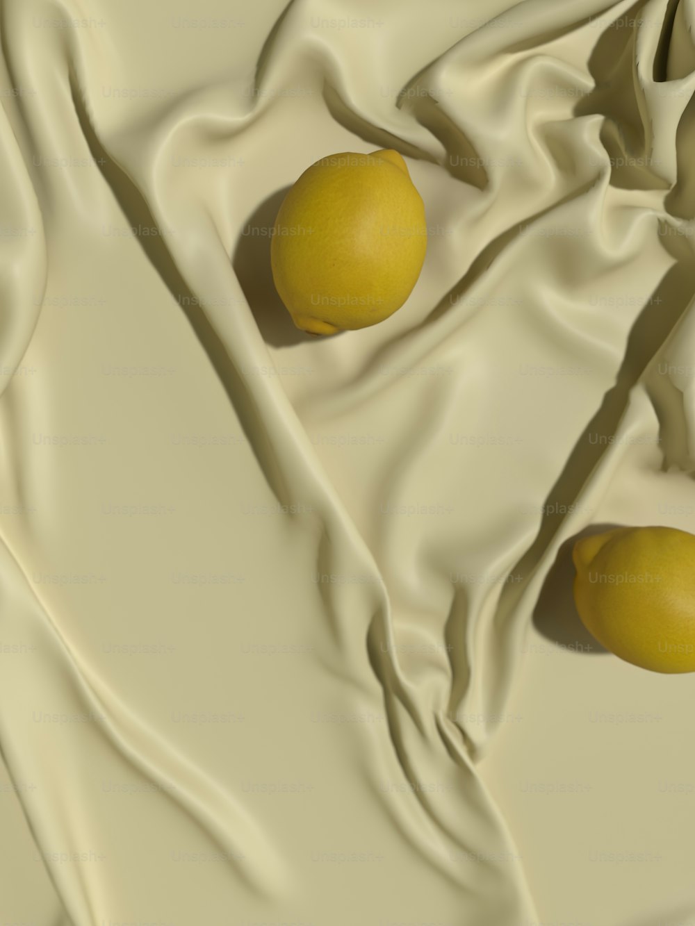 Zwei Zitronen sitzen auf einem weißen Tuch