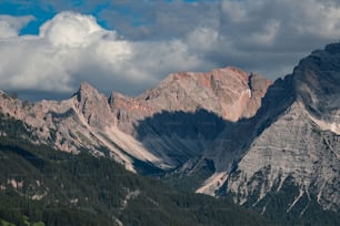a view of a mountain range with clouds in the sky