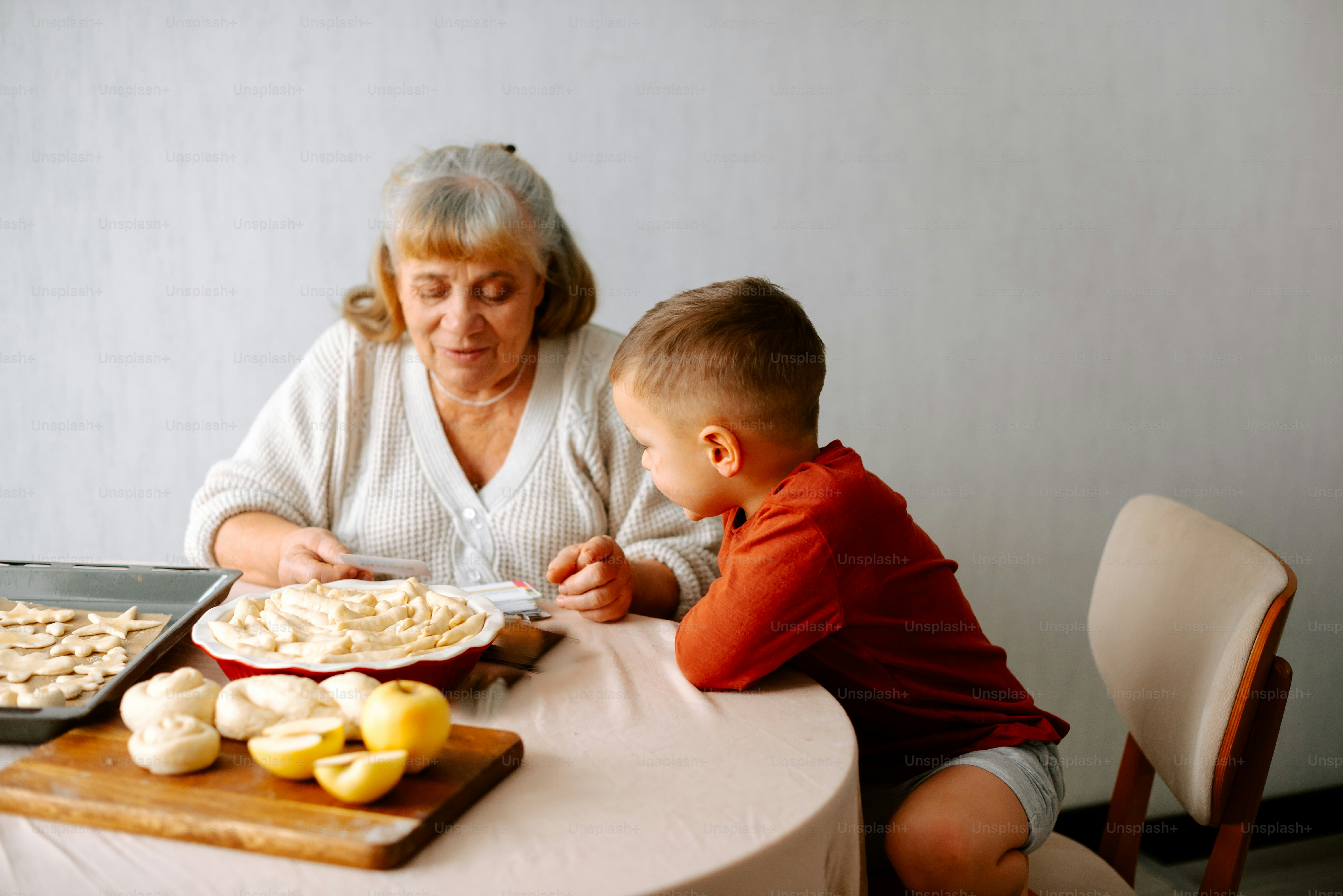 a woman sitting at a table with a child