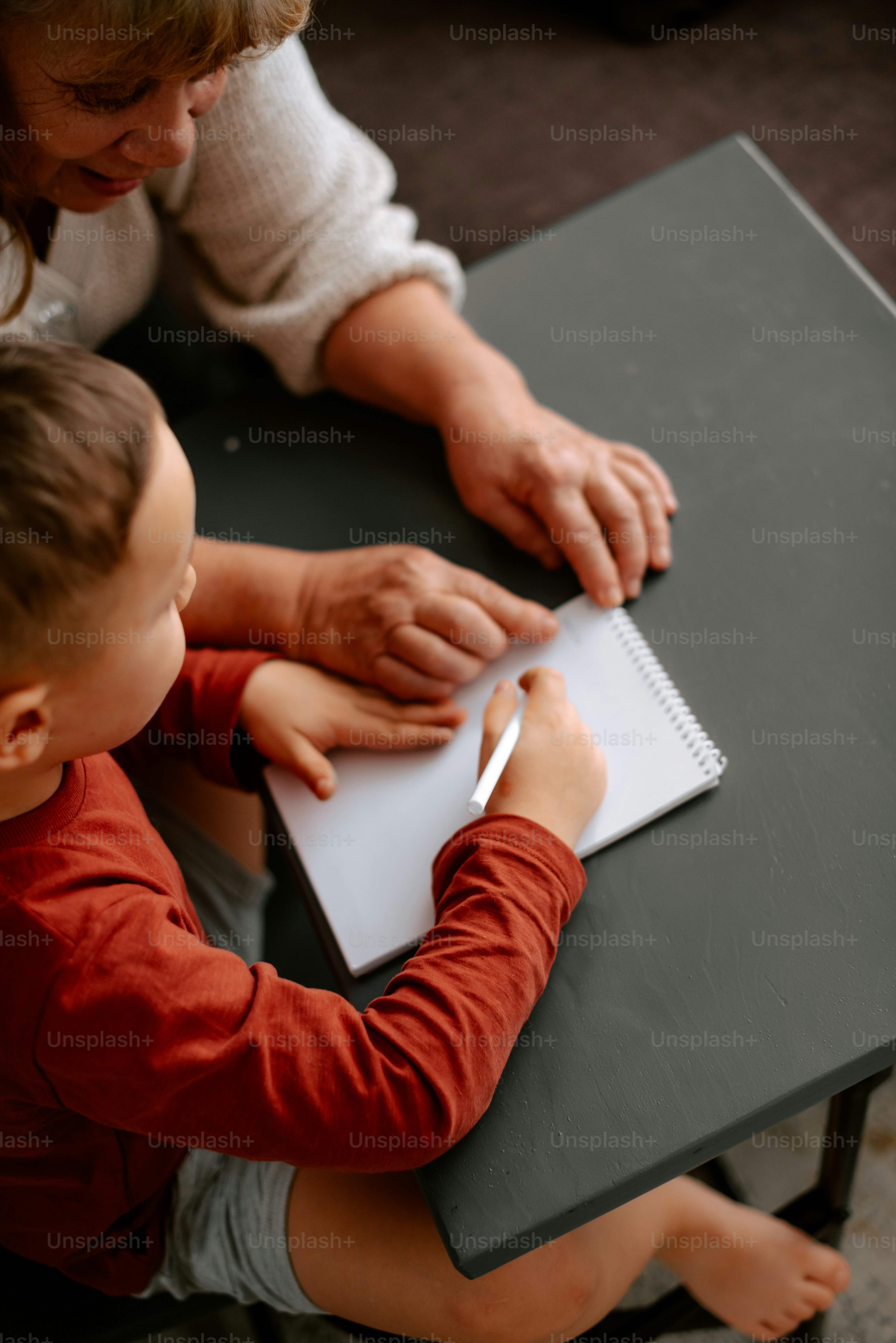 a woman and a child sitting at a table