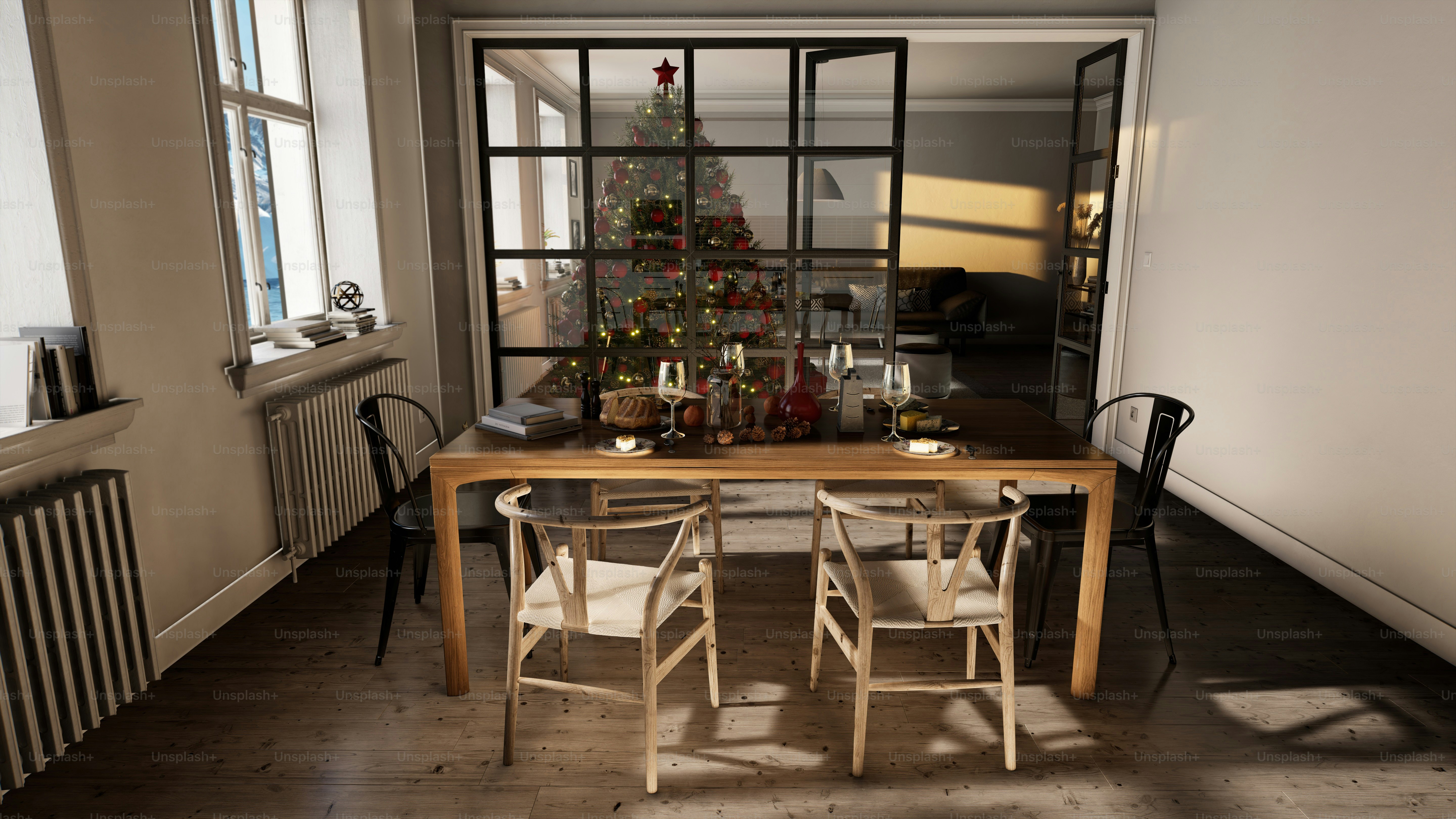 a dining room table with chairs and a christmas tree