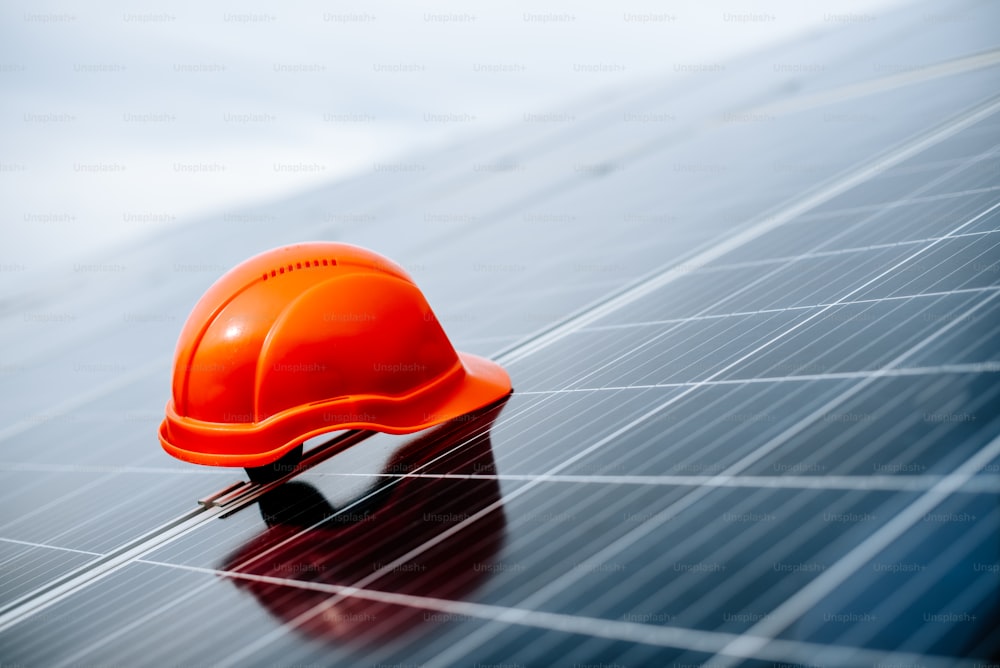 a hard hat sitting on top of a solar panel