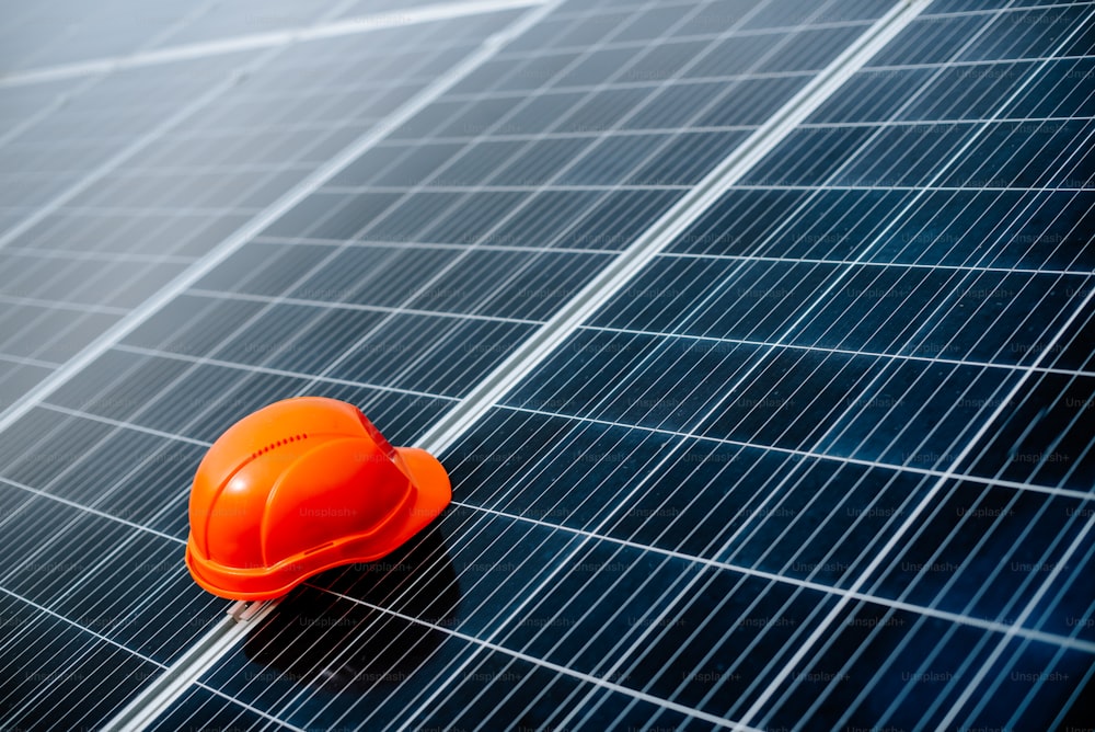 a hard hat sitting on top of a solar panel