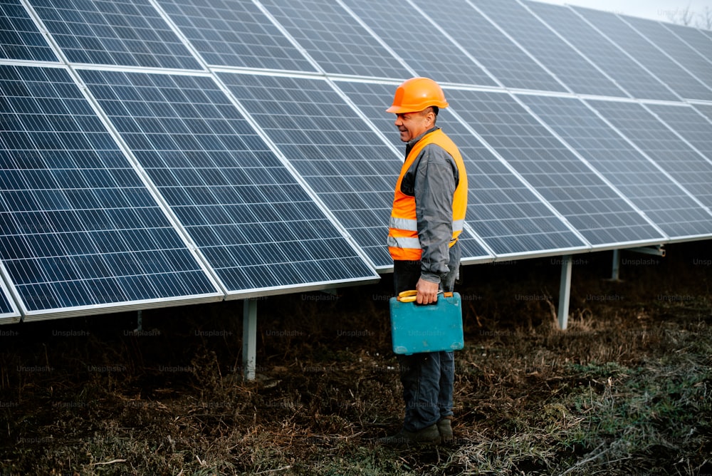 a man standing in front of a row of solar panels