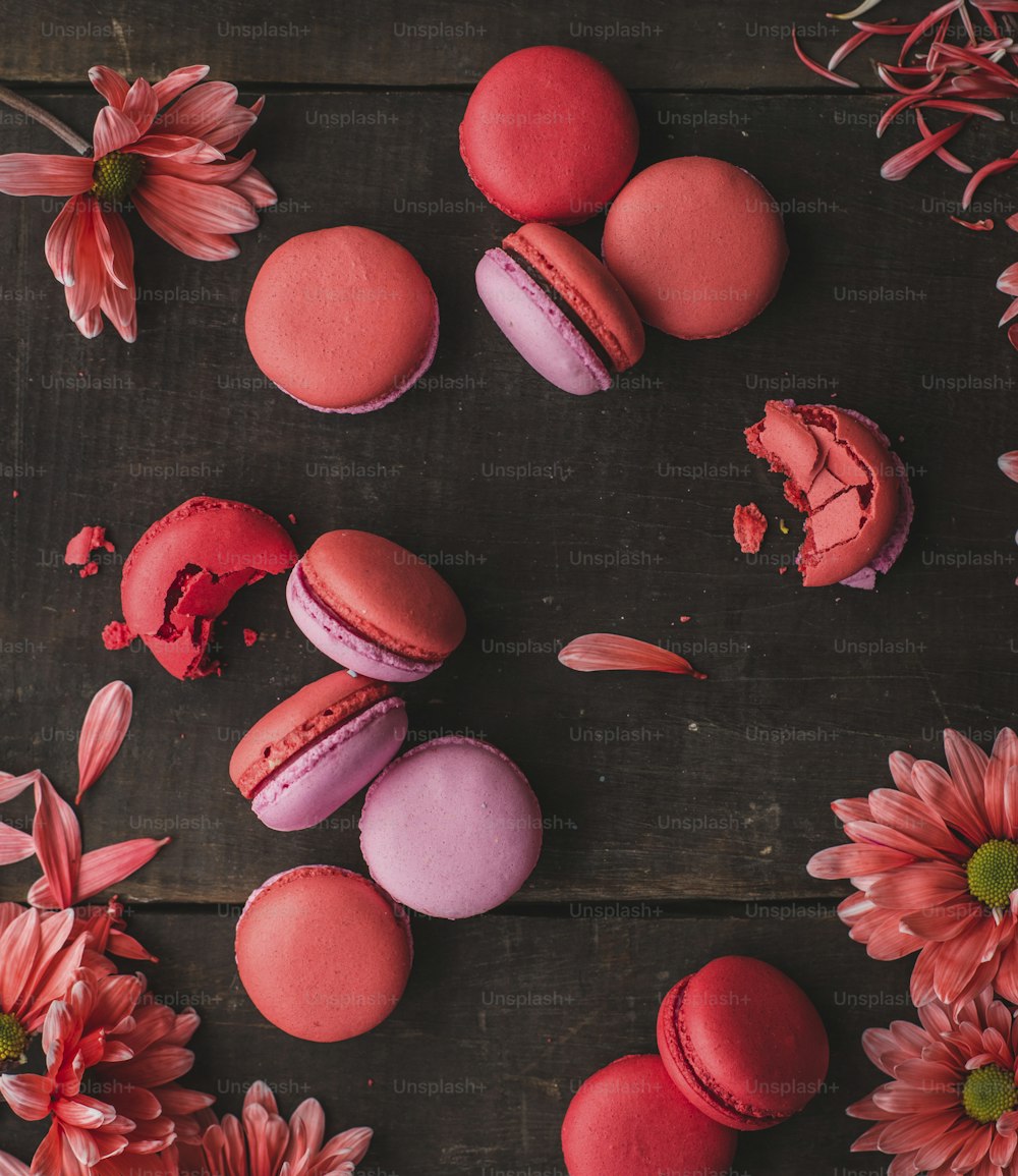 a table topped with macaroons and pink flowers