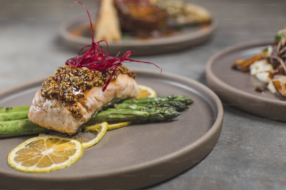 a close up of a plate of food with asparagus