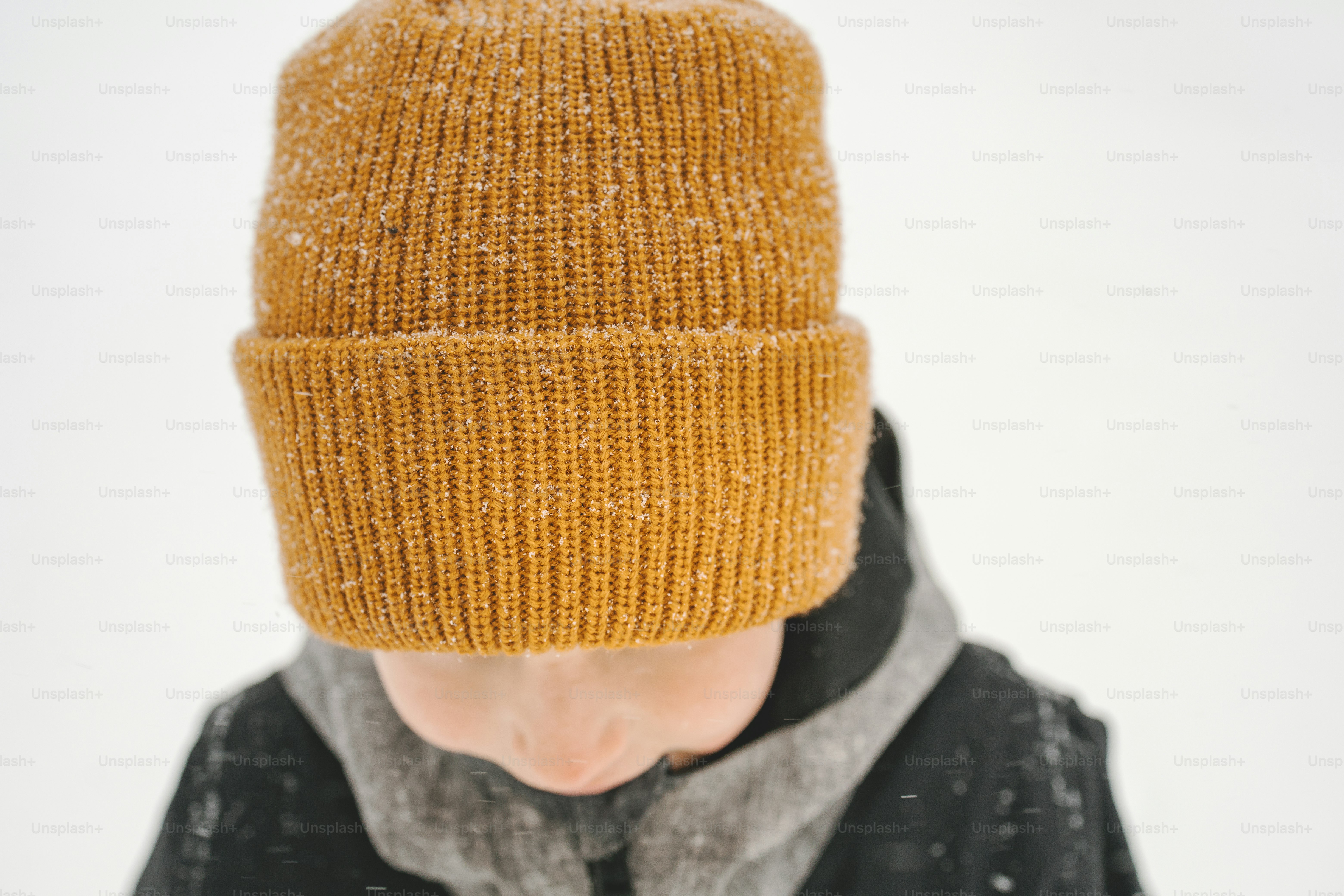 a person wearing a yellow hat and a black jacket