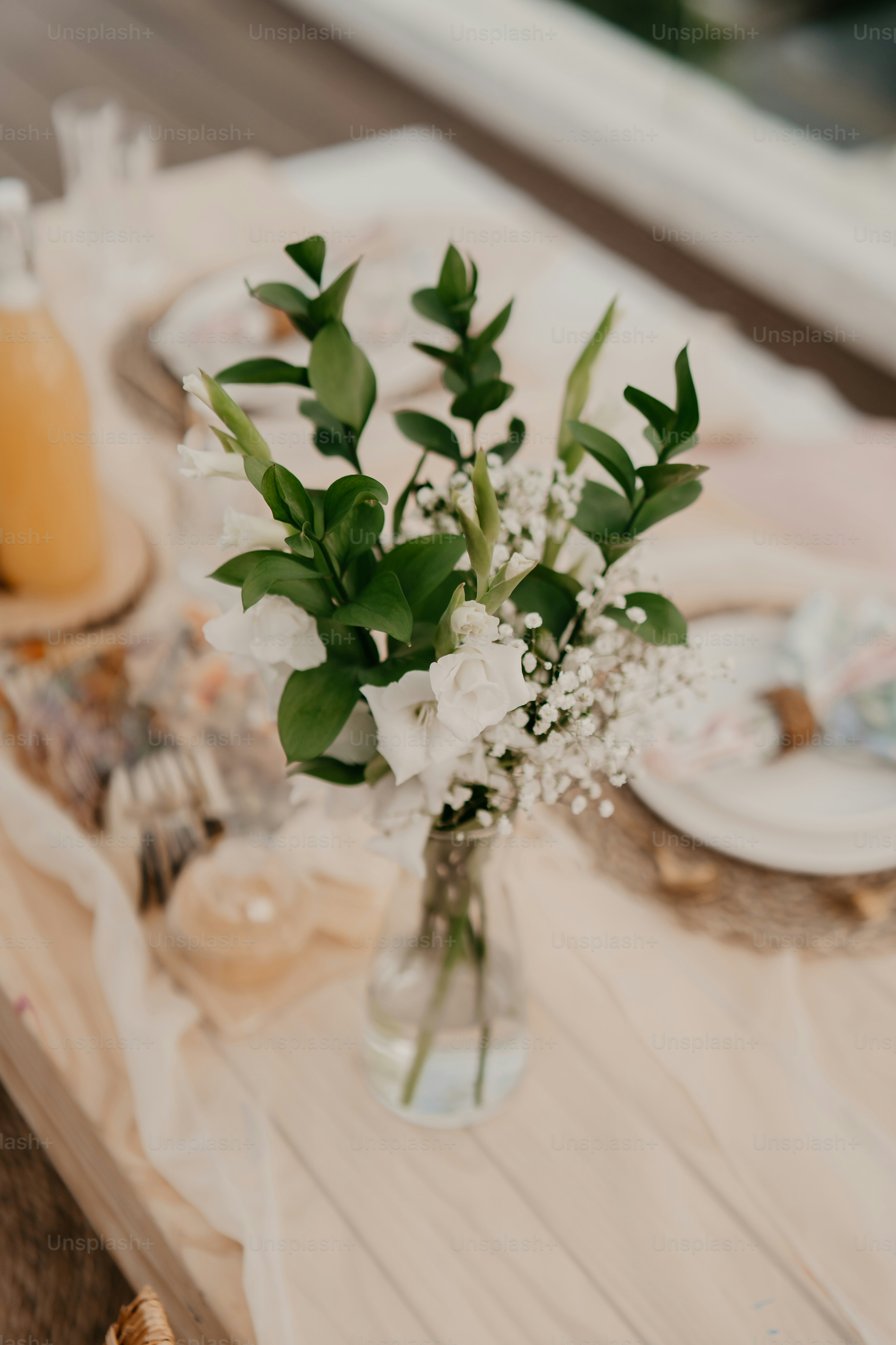 ein Tisch mit einer Vase mit Blumen darauf