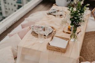 a table is set with flowers and plates