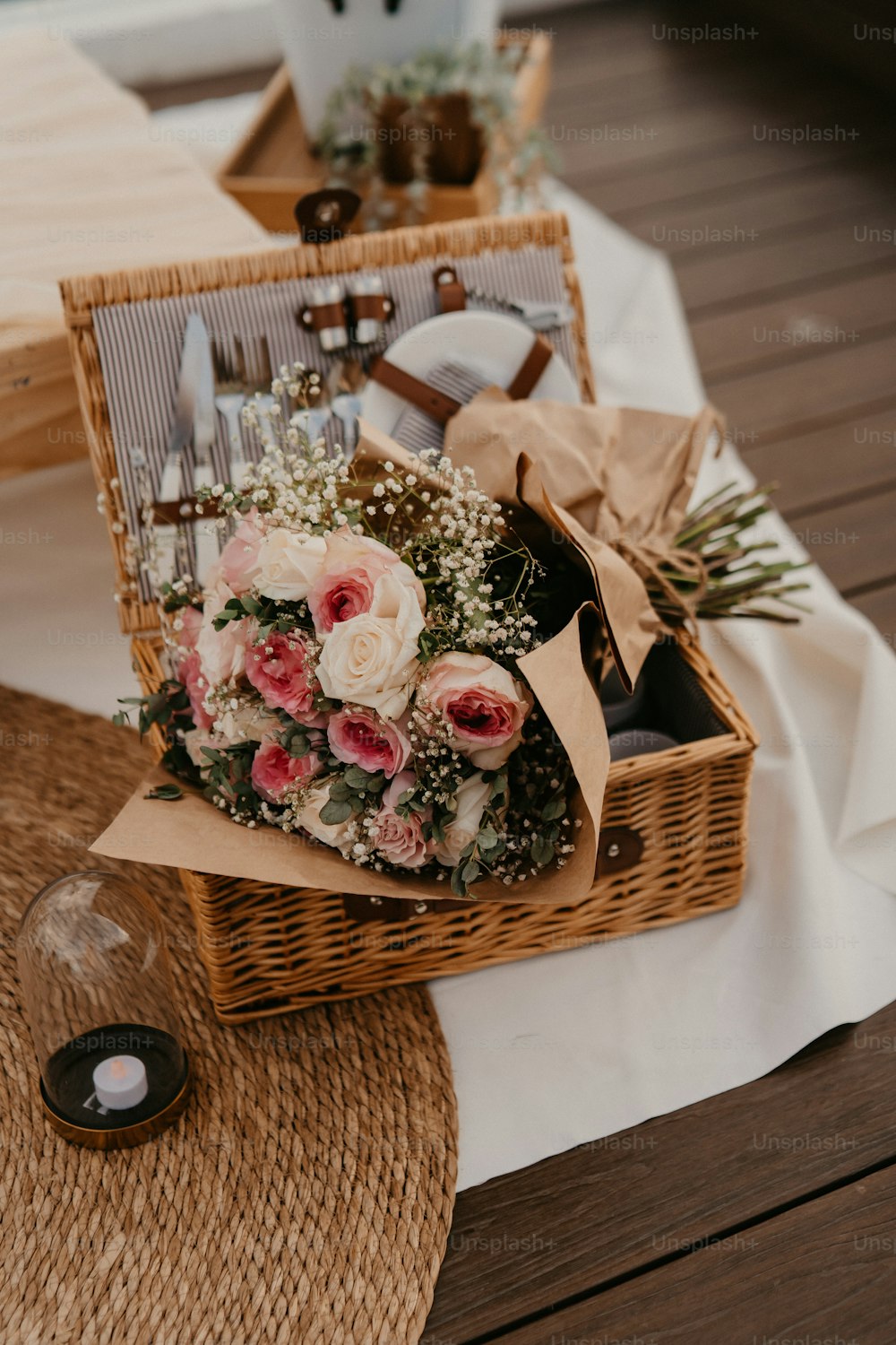 a wicker basket filled with flowers on top of a table