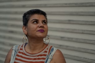 a woman with black hair wearing a striped shirt