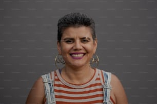 a woman with large hoop earrings and a striped shirt