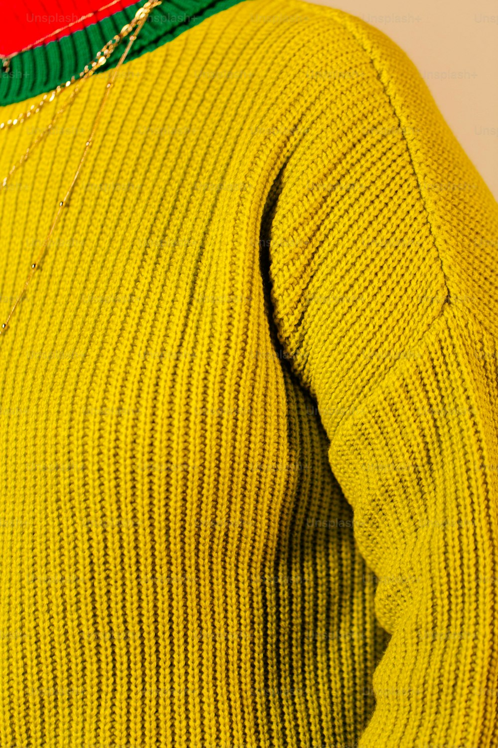 a close up of a person wearing a yellow sweater