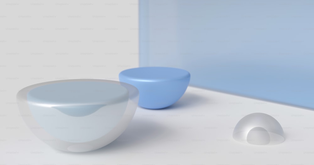 a white and blue vase sitting next to a blue bowl