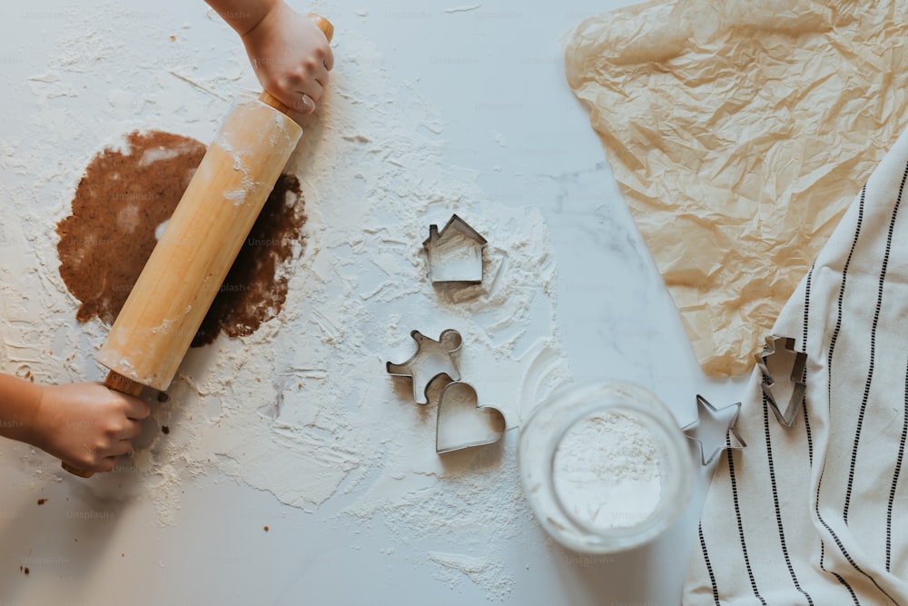 a person rolling out dough on a table