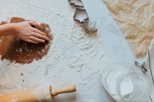 a person with their hand on a piece of paper