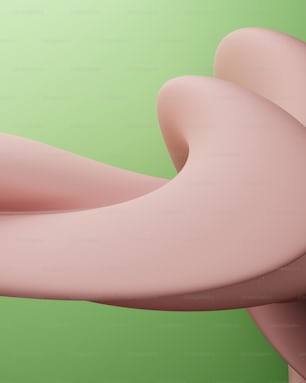 a close up of a pink object on a green background