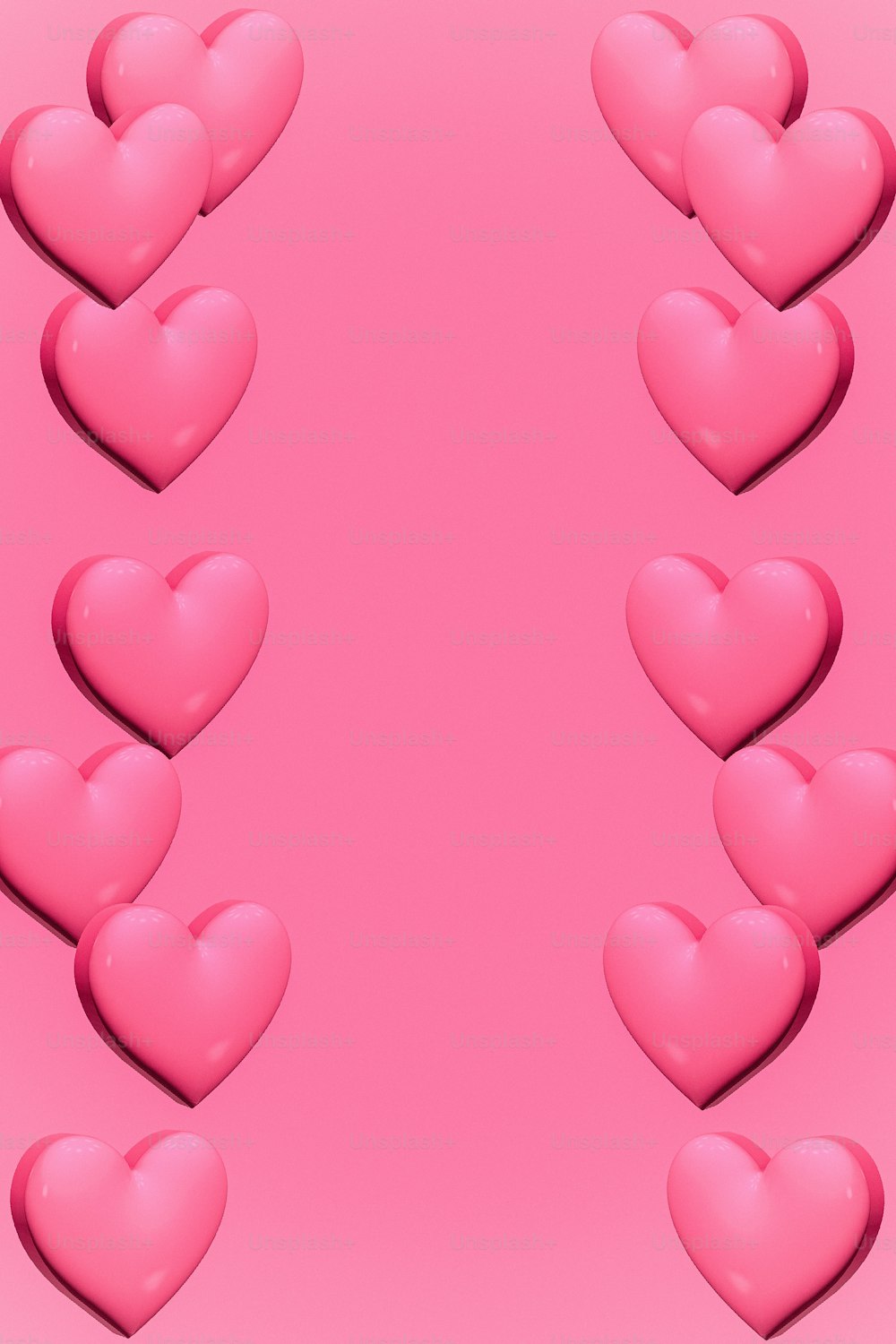 a bunch of pink hearts on a pink background