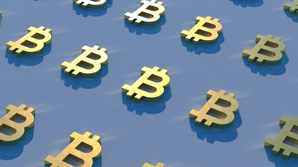 a group of golden bitcoins sitting on top of a blue surface