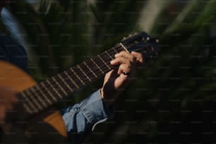 a close up of a person playing a guitar