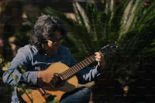 a woman playing a guitar in a garden