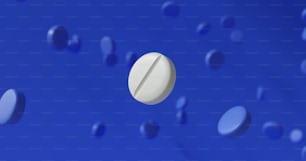 a white pill sitting on top of a blue surface