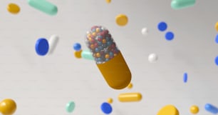 Une pilule colorée entourée de confettis sur fond blanc