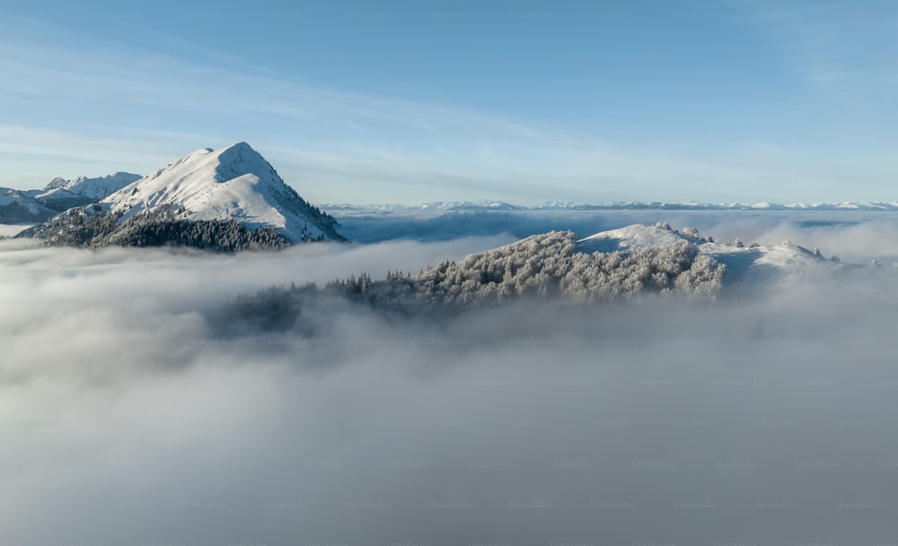 Una montagna coperta di neve e circondata da nuvole