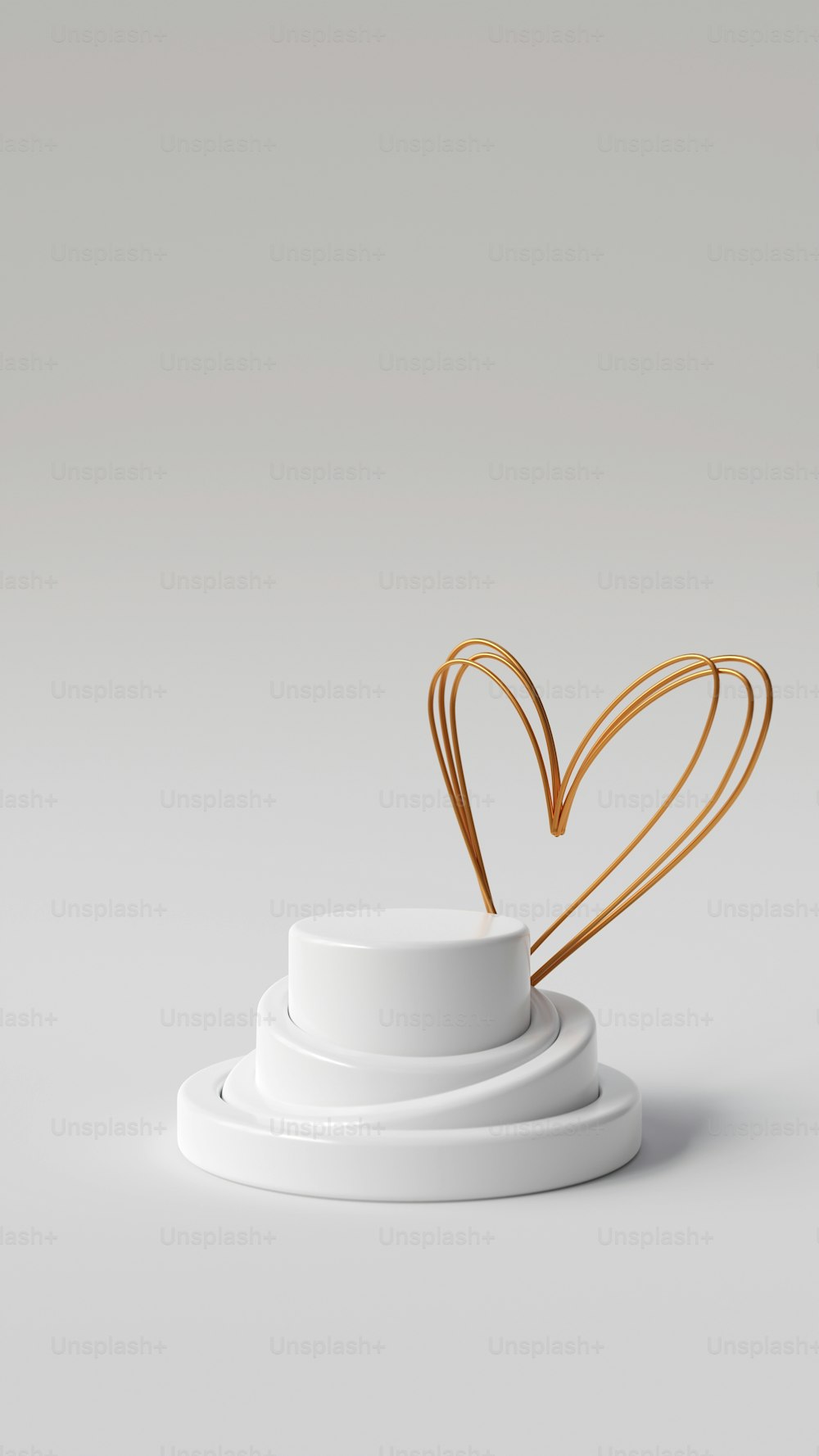 a white cup with a gold heart on top of it