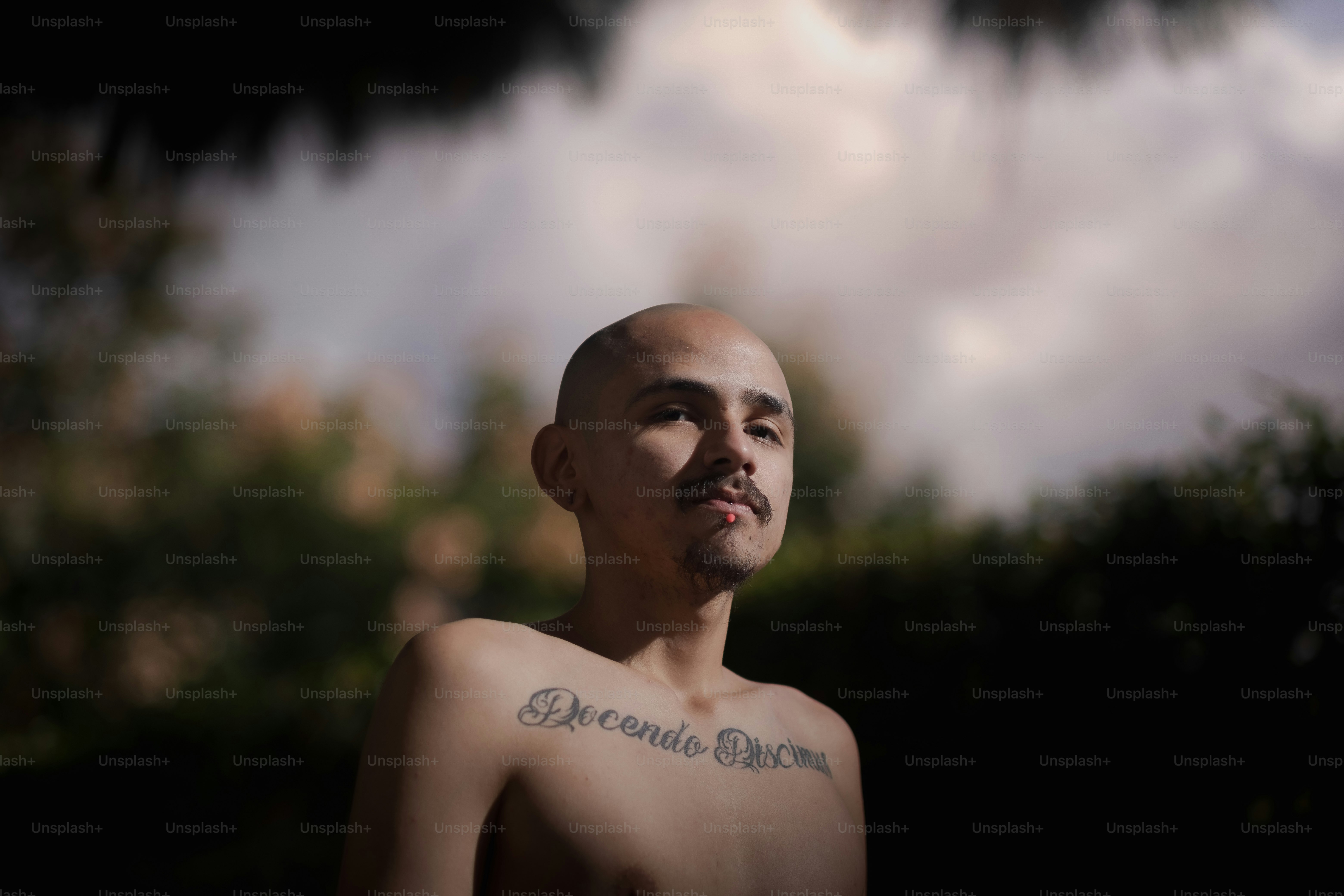 a man with a tattoo on his chest