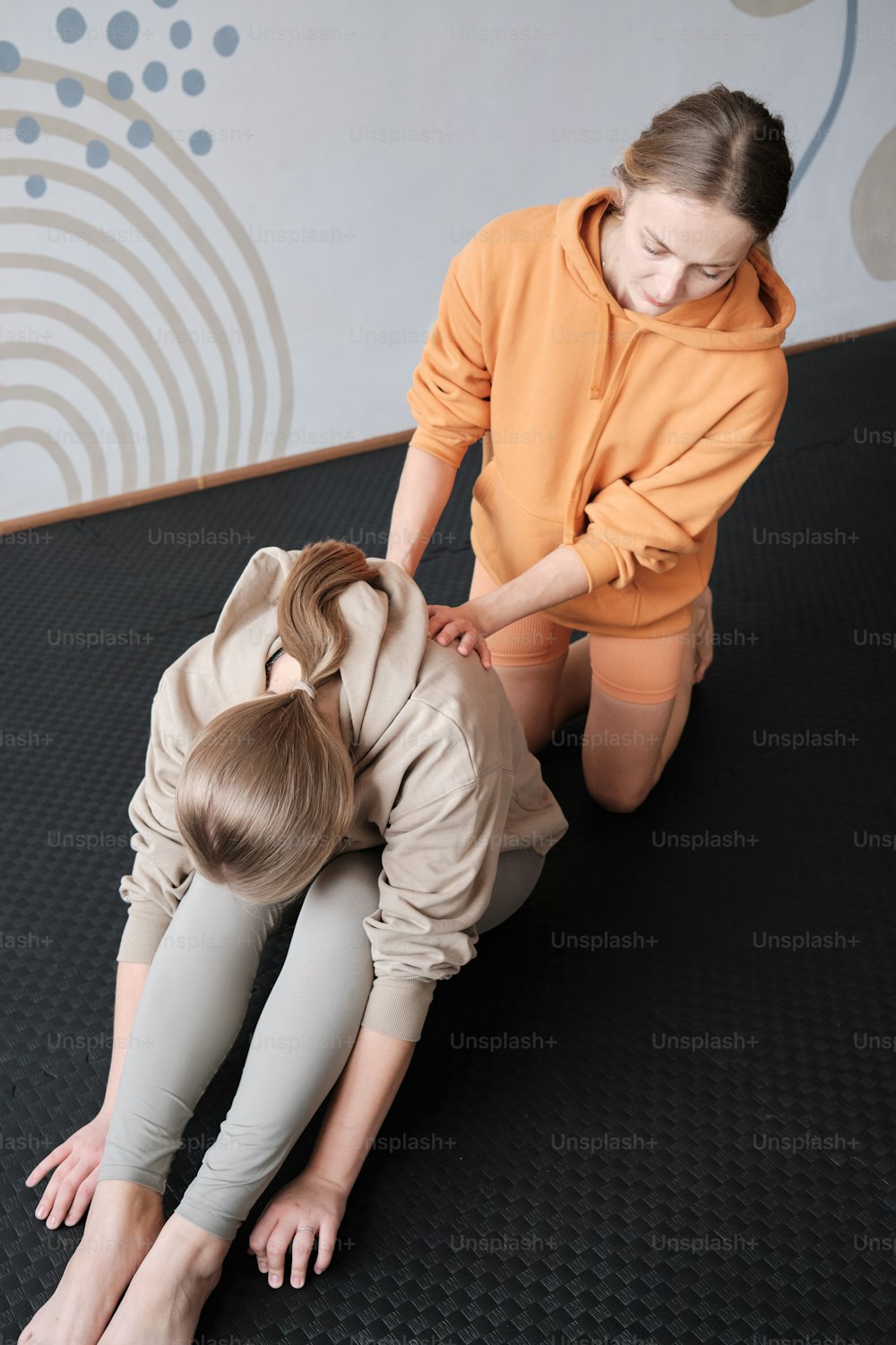 a woman and a child are sitting on the floor