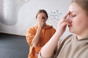 a woman holding her hand to her face