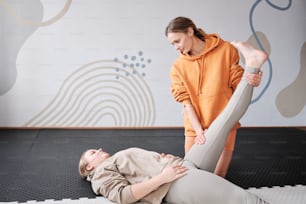 a woman doing a back massage to a baby