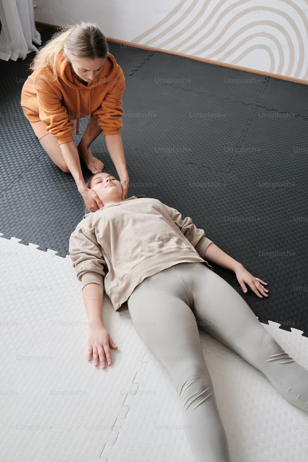 a woman is laying on the floor with a man
