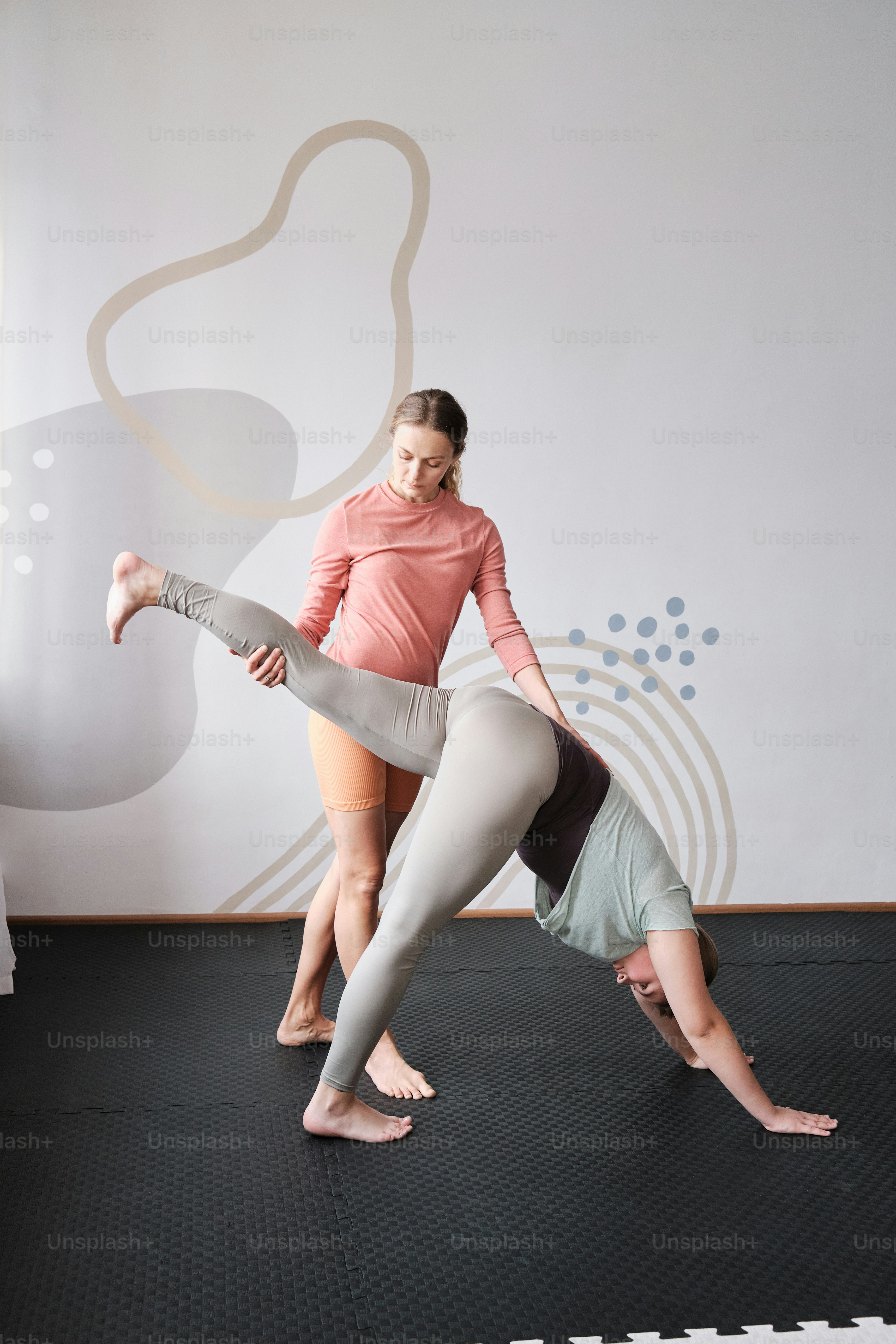 a couple of women standing on top of each other